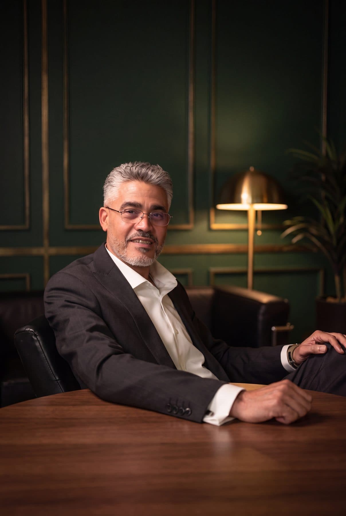 Rafael Sánchez of RSCCA leaning back in a leather chair at a walnut table.