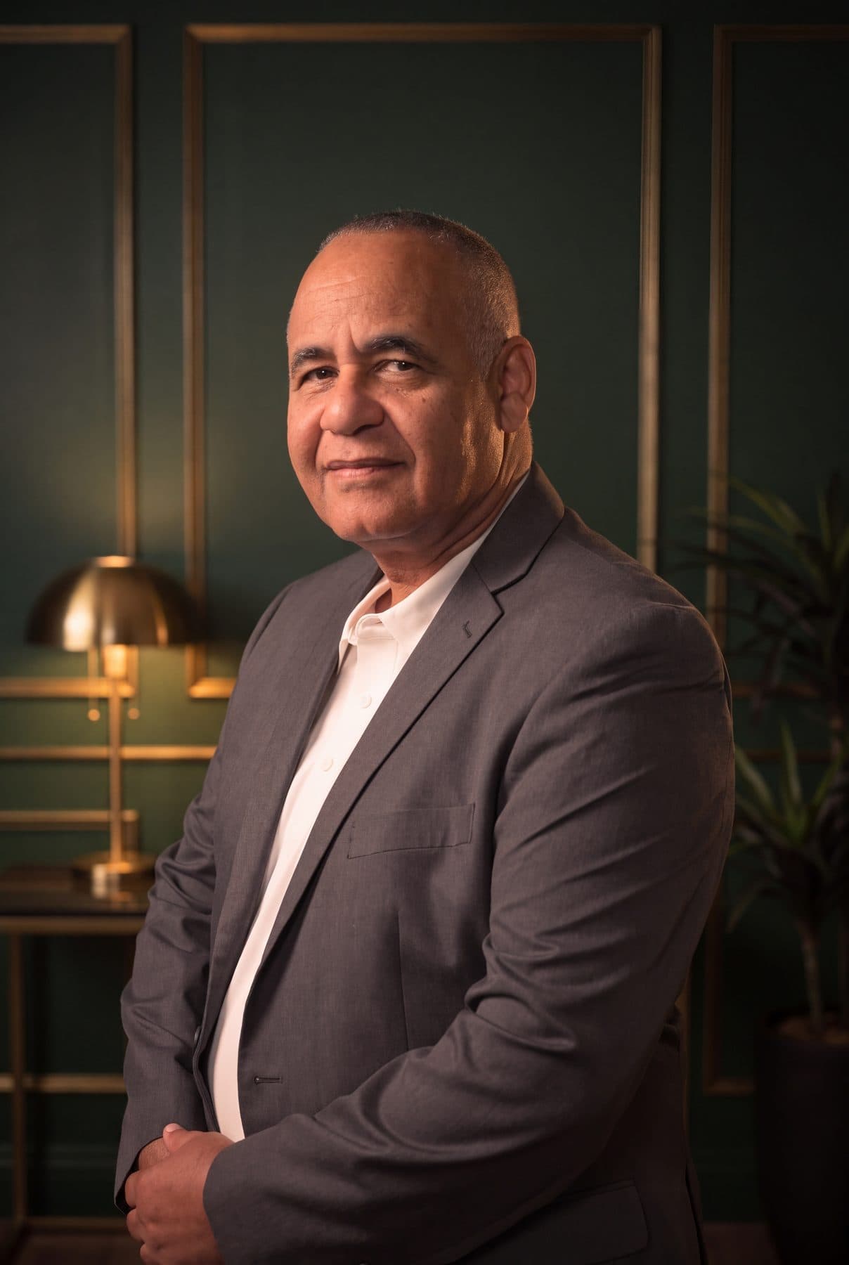 Ruben Rodriguez, co-founder and managing partner of RSCCA, standing in a green-panelled office.